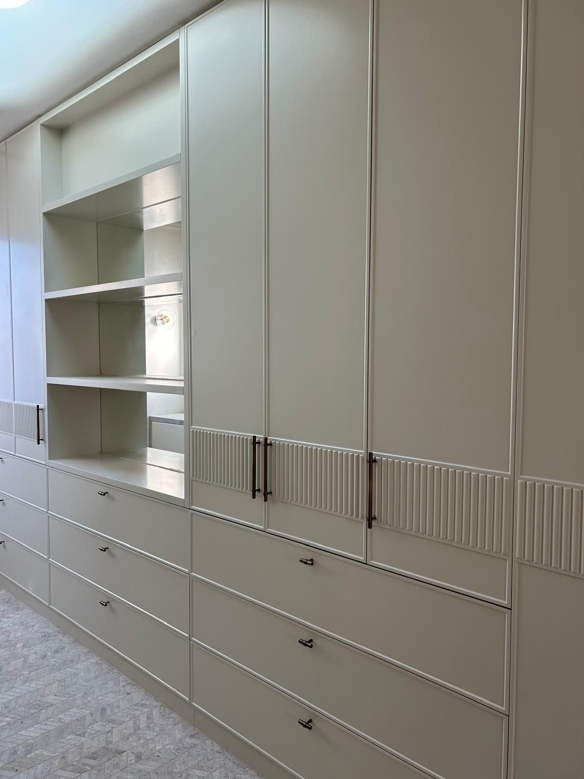 Built-in open shelving and drawers beside tall cabinetry in a residence, inner Melbourne.