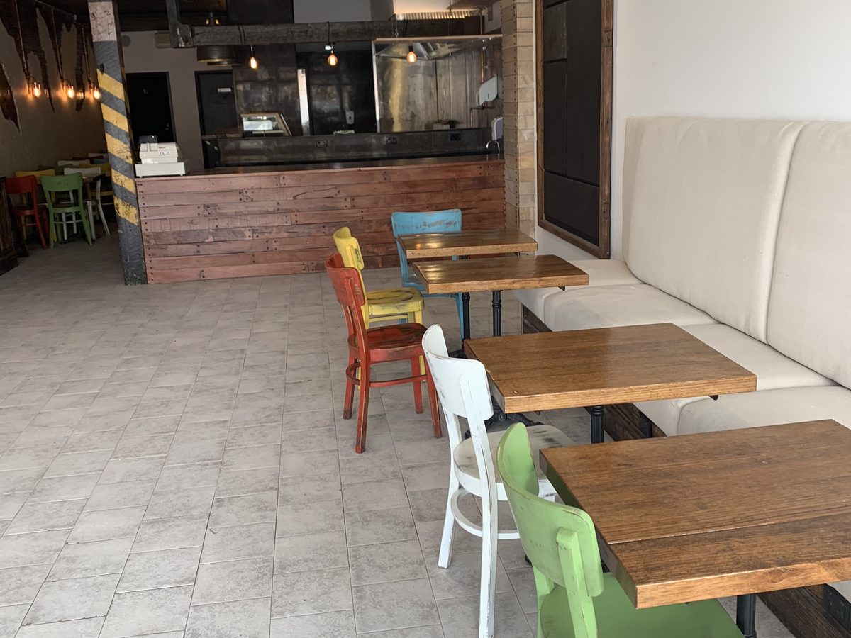 Finished restaurant dining room with an upholstered banquette and timber detailing, Coal Workshop, Melbourne’s west.