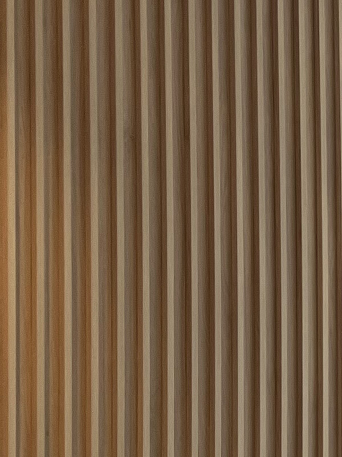 Vertical oak batten wall lining in a finished apartment, Bayside.