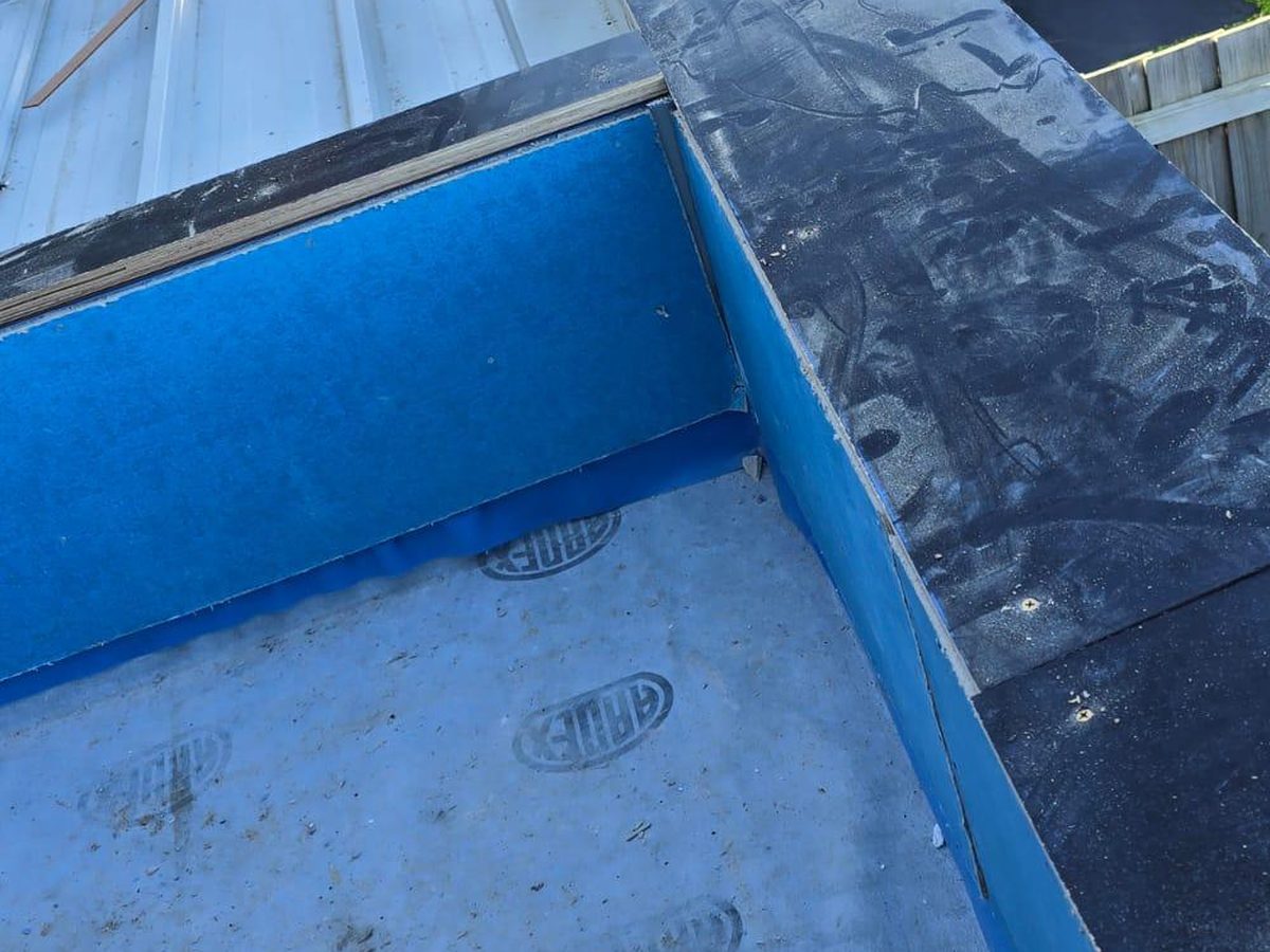 Liquid waterproofing membrane applied to the balcony upstands and the inner face of the parapet, with a self-adhesive flashing dressed over the capping, Mornington Peninsula.