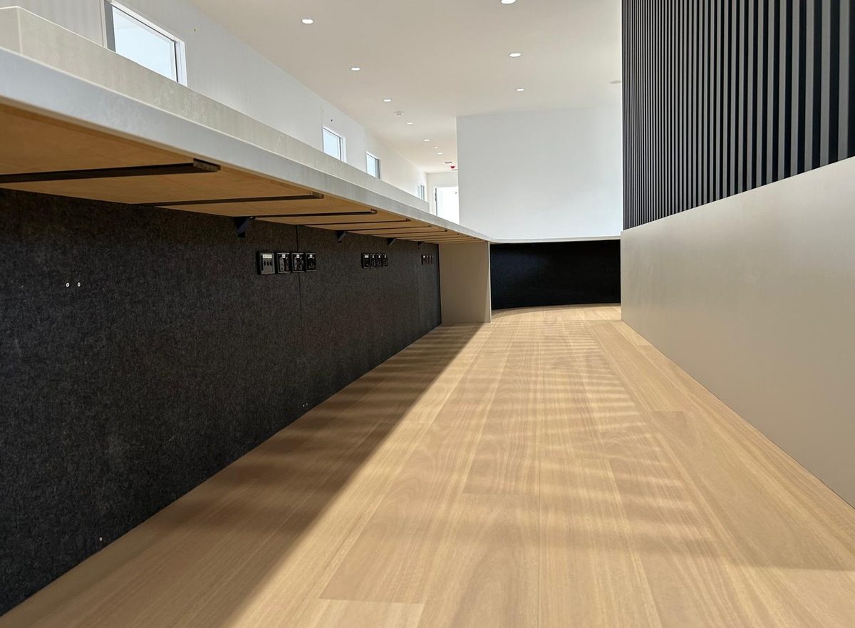 Completed commercial corridor with timber floor, battened feature wall and fitted joinery.