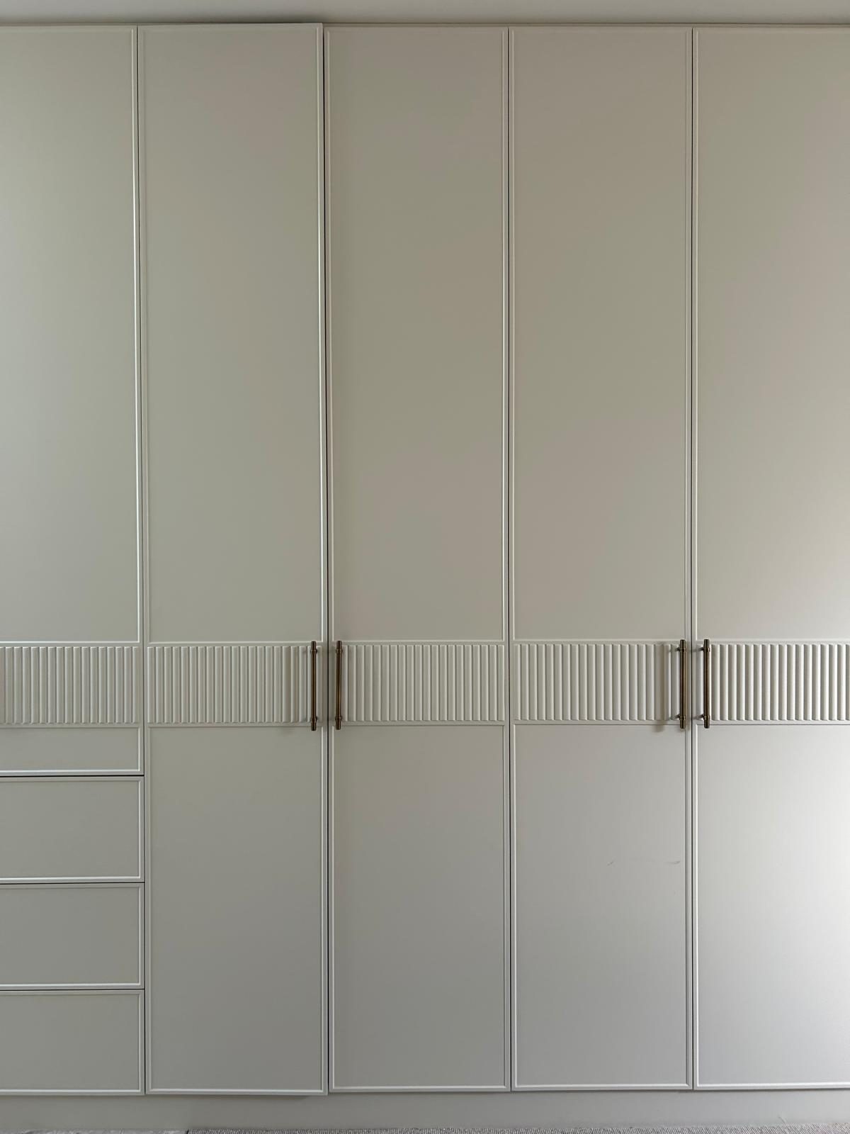 Painted feature wardrobe joinery with fluted detail in a completed residence, Cremorne.